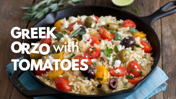 A vibrant bowl of Greek Orzo with Tomatoes, featuring tender orzo pasta, juicy cherry tomatoes, Kalamata olives, fresh basil, and crumbled feta cheese – a refreshing and flavorful Mediterranean-inspired dish.