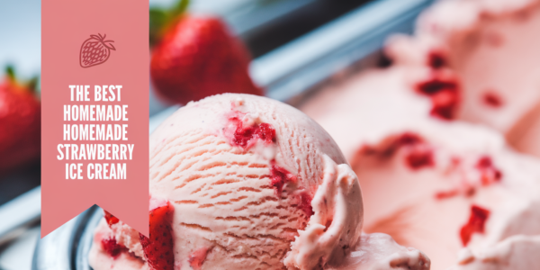 A bowl of creamy homemade strawberry ice cream topped with fresh strawberries and mint leaves, placed on a light wooden table.